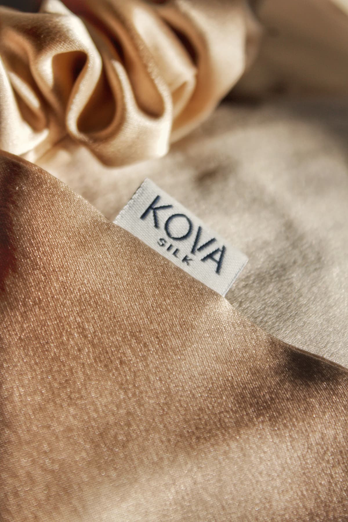 Champagne Kova Silk fabric with a silk scrunchie and woven Kova Silk label