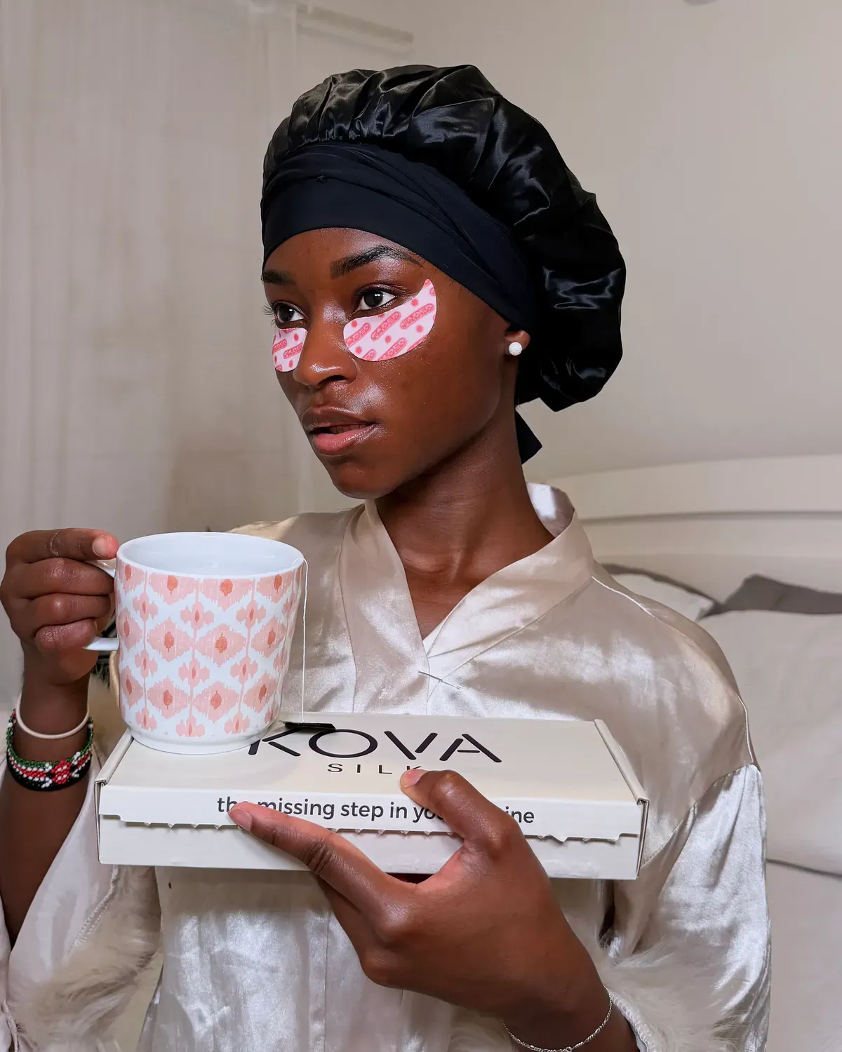 Customer wearing the black Kova Silk Secure Wrap bonnet during her nighttime routine.